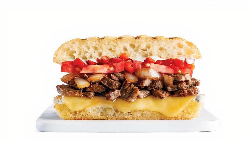 Steak & Cheese · Marinated Steak, Caramelized Onions, Tomatoes, Roasted Red Peppers & Muenster Cheese with Bistro Spread