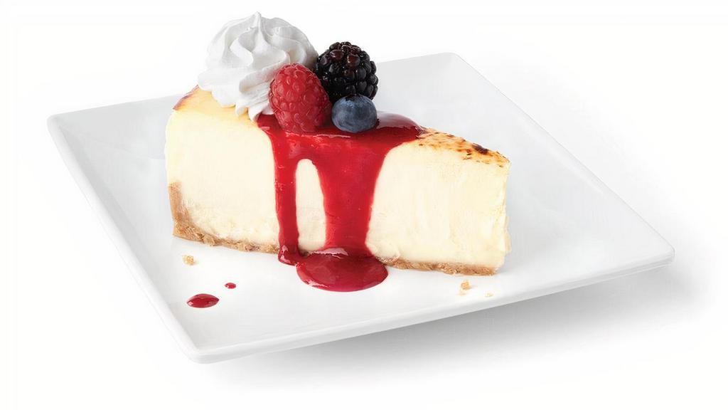 Creme Brulee Cheesecake · Decadent cheesecake, topped with raspberry coulis, mixed berries and whipped cream