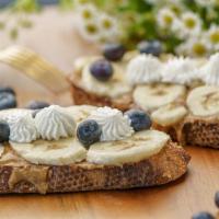 Blueberry Banana Toast · Almond butter, banana, blueberry, homemade whipped cream
