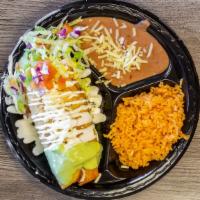 Chimichanga Platter · Deep fried burrito and shredded beef topped with lettuce, guacamole, cheese, and cream. Serv...