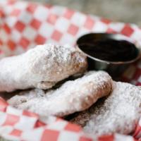 Beignets · Our unique spin – fried dough, powdered sugar, served with blueberry lavender jam.