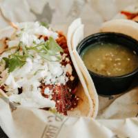 Bbq Pork Tacos · Pulled pork simmered in sweet BBQ sauce served on soft corn tortillas with coleslaw, cilantr...