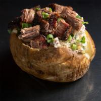 Pork Baked Potato · Jumbo baked potato filled with a creamy blend of butter, sour cream, cheddar cheese, bacon, ...