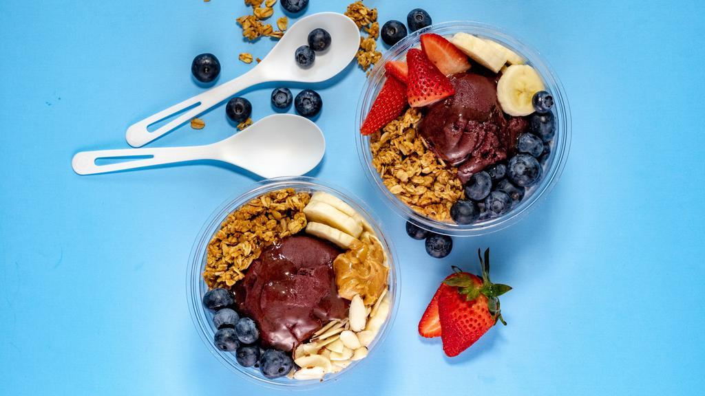 The Nuts · Organic Acai topped with Organic Granola, Fresh Strawberries and Bananas,  Peanut Butter, Honey and Coconut