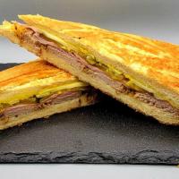 Cuban Sandwich · Kalua pork, ham, pickles, mustard, Swiss cheese on a fresh roll.