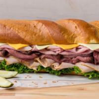 All American Super Sub Sandwich · Turkey Breast, Honey Ham, Roast Beef, Cheddar and Leaf Lettuce on Scratch Made French Bread....