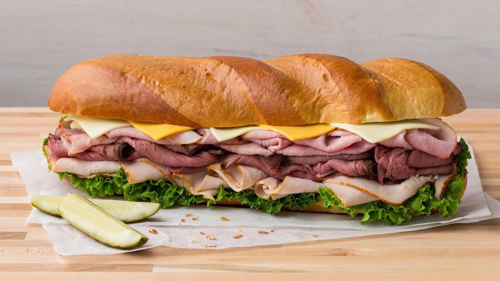 All American Super Sub Sandwich · Turkey Breast, Honey Ham, Roast Beef, Cheddar and Leaf Lettuce on Scratch Made French Bread. No substitutions.