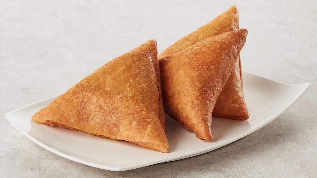 Samosa Vegetable · Parsley infused pastry surrounds this medley of vegetables tossed in a warm savory seasoning. Peas, carrots and potatoes make this a favorite meal and one of our top sellers.