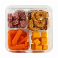 Deli Snack Salami & Cheese · Hard Salami cubed for snacking, Mild Cheddar Cheese, Baby Carrots and Pretzel Crisps.