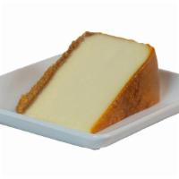 Colossal Cheesecake Slice · New York style cheesecake on a buttery graham cracker crust.