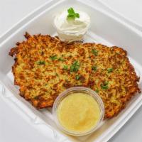 Potato Pancakes · Two homemade potato pancakes with applesauce and sour cream.