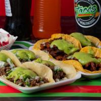 Tacos De Asada (Harina) · Tacos come with guacamole, onion and cilantro.