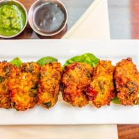 Vegetable Pakoras · Mixed vegetables coated in seasoned chickpea batter and fried. Served with mint and tamarind...