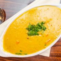 Masra Dahl · Simmered yellow lentils cooked with sauteed garlic, onions and ginger. V-GF-NF