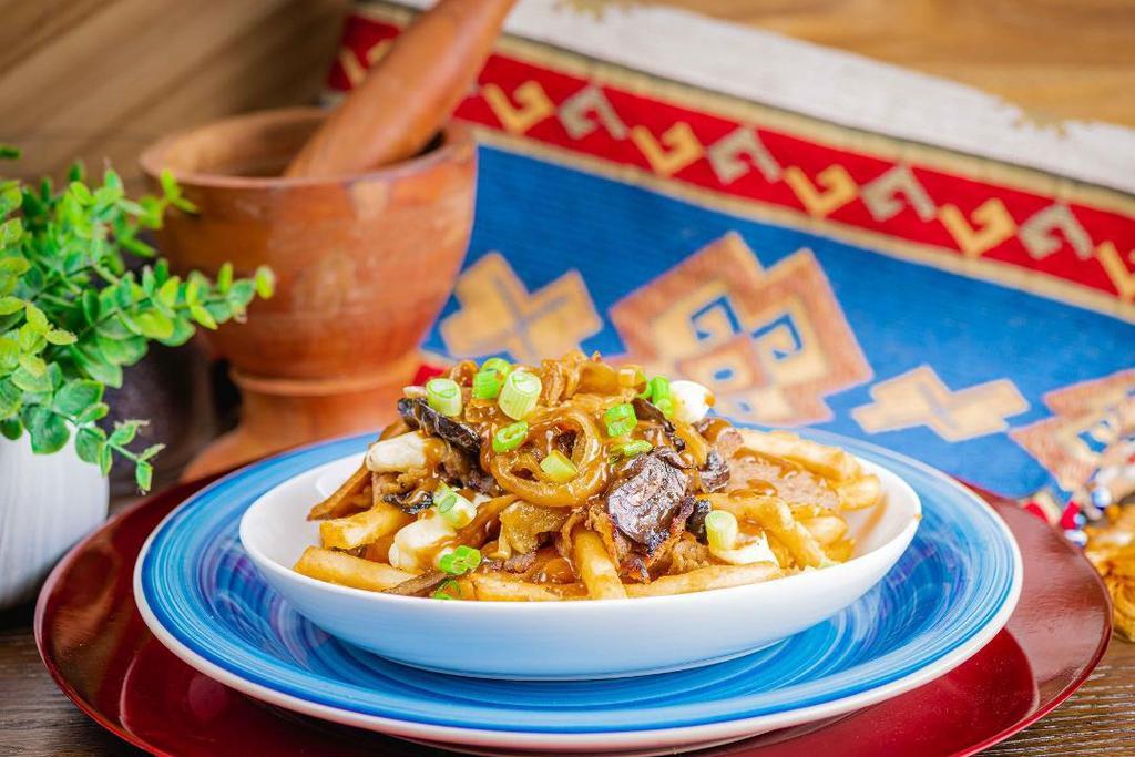 Steakhouse Poutine · Gravy, cheese curds, donair meat, sauteed onion and mushroom, green onion.