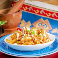 Buffalo Chicken Poutine · Gravy, cheese curds, crispy hand breaded chicken, buffalo sauce, ranch drizzle, green onion.