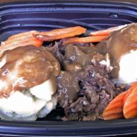 Pot Roast Meal · Tender beef pot roast and mashed potatoes with brown gravy and fresh carrots.