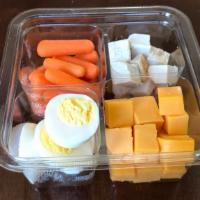 Deli Snack Protein Pack · Store roasted turkey breast cubed for snacking, mild cheddar cheese, baby carrots, and hard ...