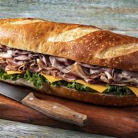 All American Super Sub Sandwich · Turkey breast, honey ham, roast beef, cheddar, and leaf lettuce on French bread. No substitu...