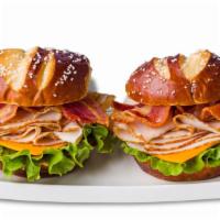 Turkey Bacon Cheddar Pretzel Duo Sandwiches · Sliced turkey breast, bacon, cheddar and leaf lettuce on pretzel buns. Served with mustard a...