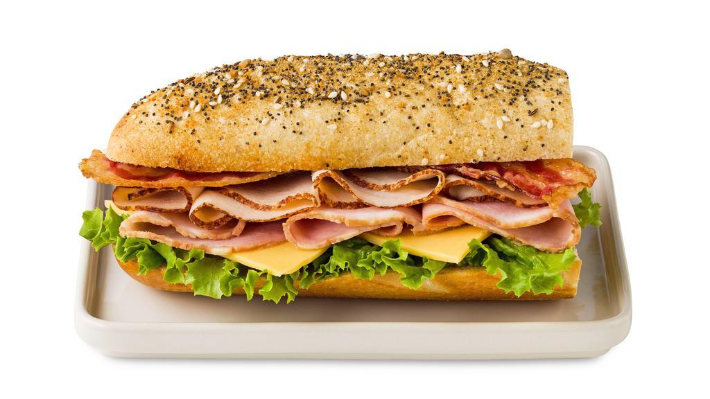 Ham & Turkey Club On Everything Sandwich Roll · Sliced turkey breast, ham, bacon, American cheese and leaf lettuce on fresh-baked everything seasoned bread roll. Served with mustard and mayo on the side.