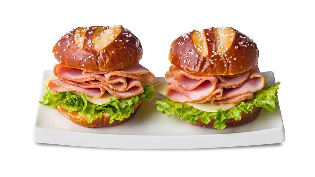 Ham & Swiss Pretzel Duo Sandwiches · Two pretzel buns each with sliced ham, mild Swiss cheese and leaf lettuce. Served with mustard and mayo on the side.