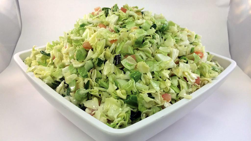 Summer Slaw Salad · Crisp, sweet, summer crunch made up of diced green cabbage, diced tomatoes, green onion, and cucumber in a light coleslaw dressing.