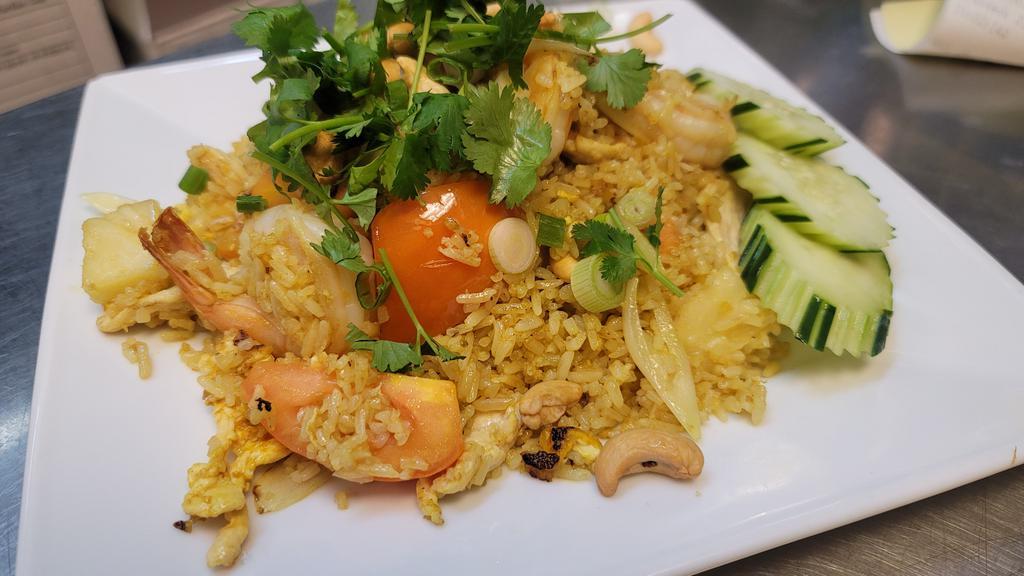 Pineapple Fried Rice · Chicken and shrimp stir-fried with rice, egg, tomato, diced carrot, green onion, onion, pineapple and cashew nuts.