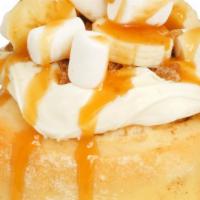 Bananas Foster Roll · Almond  frosting topped with fresh bananas, caramel sauce, and brown sugar sprinkle.