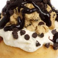 Cookie Dough Monster · Cake Batter rosting topped with homemade Cookie Dough, Chocolate Chips and Chocolate Sauce.