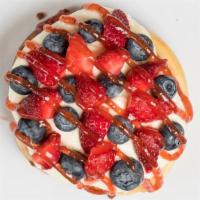 Captain America Roll · Cream Cheese frosting, blueberries, strawberries and strawberry jam.