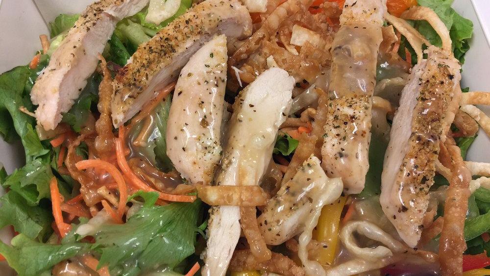 Oriental Chicken Salad · Greens topped with chicken breast, snow peas, chow mein noodles, carrots and red peppers with sesame ginger vinaigrette.