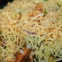 Samosa Channa Chaat · A chaat bowl of two crushed samosa pieces, chickpea masala, and other savory toppings, chutn...