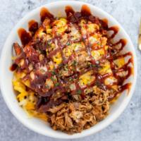 Sweet Piggy Mac Bowl · A delicious bowl of sweet potato fries smothered in ma and cheese and BBQ pulled pork.