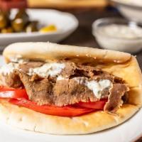 Gyro Pita · Hand-carved tradition gyro roasted on a vertical rotisserie. Served on fresh pita bread with...