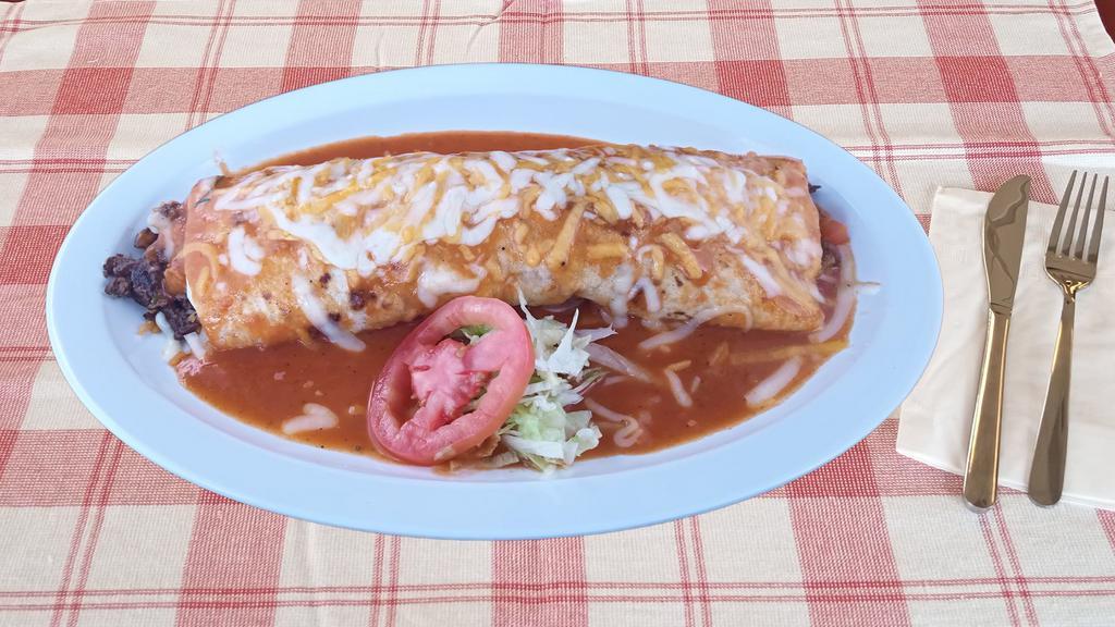 Burrito Chipotle · Choice of meat, onions, cilantro, wet in a chipotle base sauce, includes rice and beans, regular salsa.