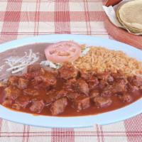 Pork Chile Colorado · Pork chunks cooked in red sauce. Served with rice & beans. Choice of flour or handmade corn ...