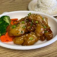 Sesame Chicken · Stir-fried crispy chicken with sesame sauce with steamed broccoli and carrot. Served with ja...