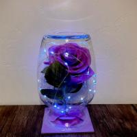 Liliac’S Lie  · Purple enchanted rose with led lights and fallen petals.