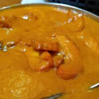 Chicken Makhani (Butter) · Tandoor-barbecued boneless chicken thigh chops cooked with, onions, ginger garlic, fresh tom...