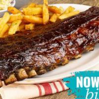 Smoked Baby Back Ribs · Hickory-smoked in-house and grilled with a tangy BBQ sauce. Served with two sides.