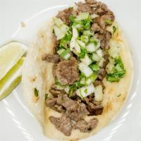 2 Tacos De Carne Asada · Soft corn tortillas filled with char-broiled steak, pico de gallo and guacamole, covered wit...