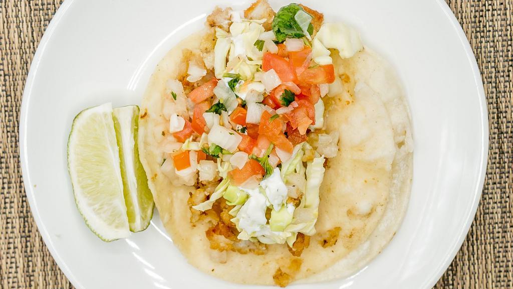 2 Fish Tacos · Served with rice and beans.