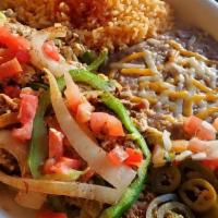 Machaca & Eggs · Three eggs scrambled with shredded beef, bell peppers, onions, and tomatoes. Garnished with ...