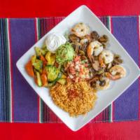 Camaron Al Mojo · Plump grilled shrimp and mushrooms sautéed in a garlic butter sauce. Served with rice, grill...