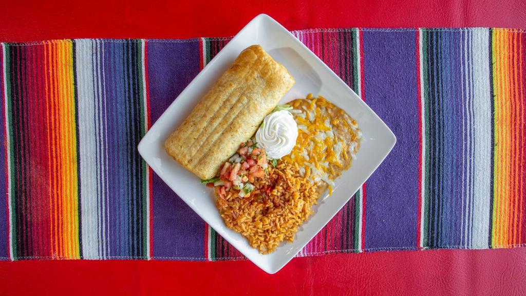 Chimichanga · Beans, cheese and your choice of meat: shredded beef, shredded chicken, ground beef, chile verde or chile colorado. Rolled in a flour tortilla and deep-fried to a golden crisp. Garnished with pico de gallo, lettuce and sour cream.