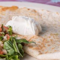 Quesadilla · Flour tortilla with our melted Mexican cheese blend, pico de gallo, lettuce, and sour cream