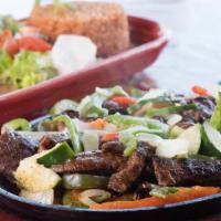 Fajitas · Chicken or steak sizzling hot over a bed of sauteed onions bell peppers zucchini and mushroo...