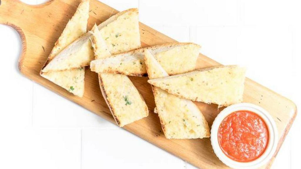 Parmesan Bread · Rustic baguette toasted with herb-garlic butter and parmesan. Served with a side of marinara sauce.