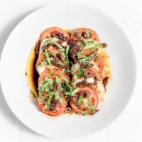 Caprese Salad · Fresh mozzarella, Roma, sun-dried tomatoes, fresh basil, Kalamata olives, olive oil, and bal...